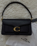 Black Handbag - top view with Coach packaging