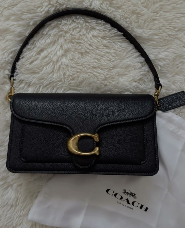 Black Handbag - top view with Coach packaging